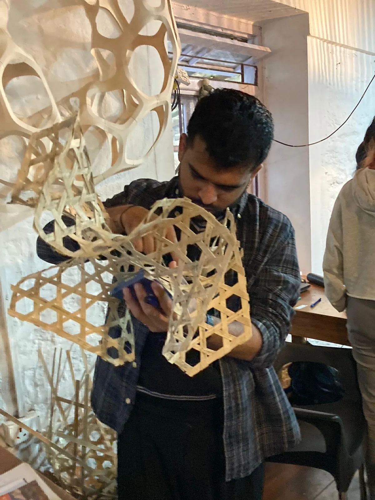 A workshop participant exploring a freeform bamboo prototype