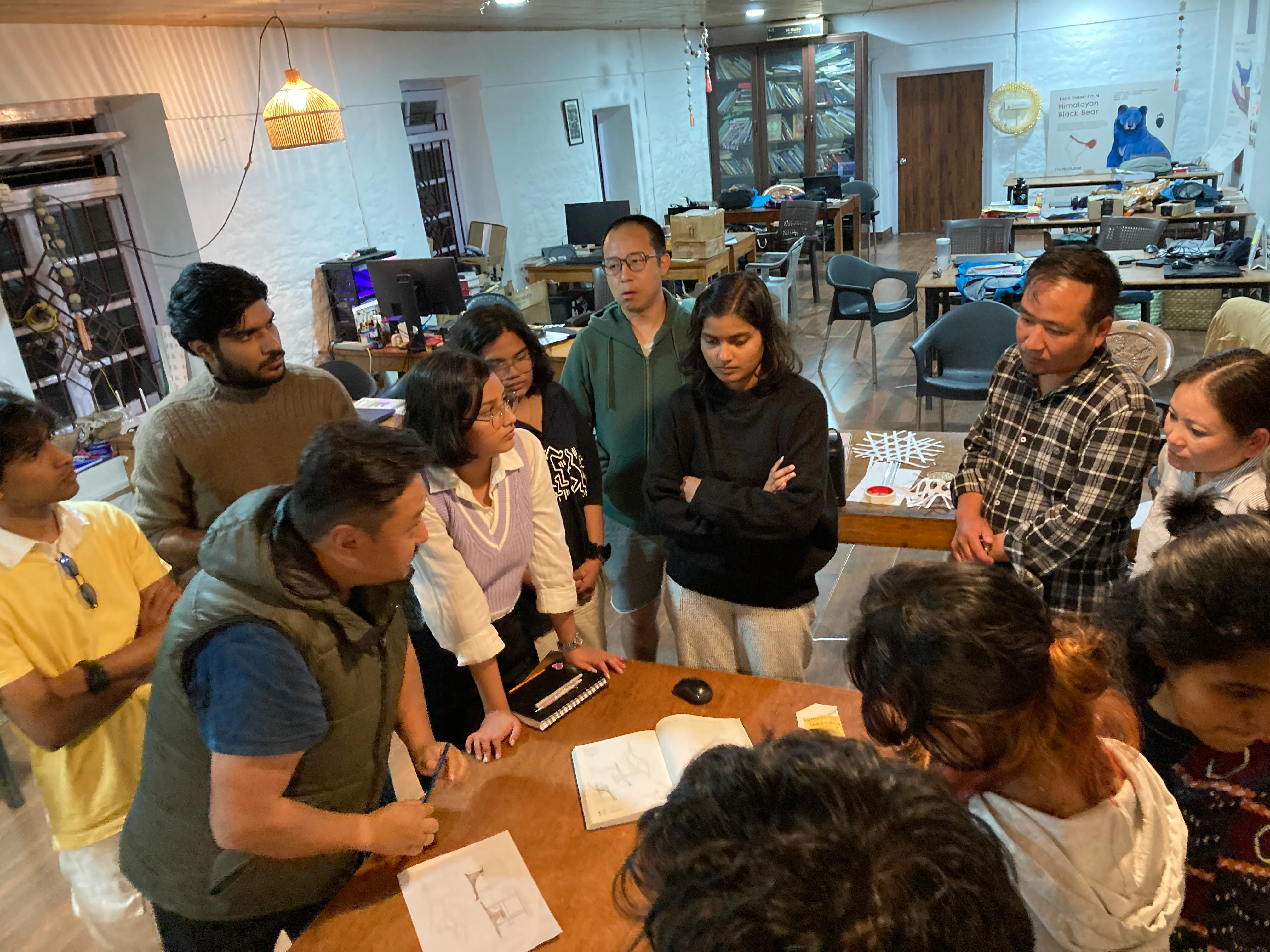 Workshop participants discussing the direction of the large bamboo pavilion