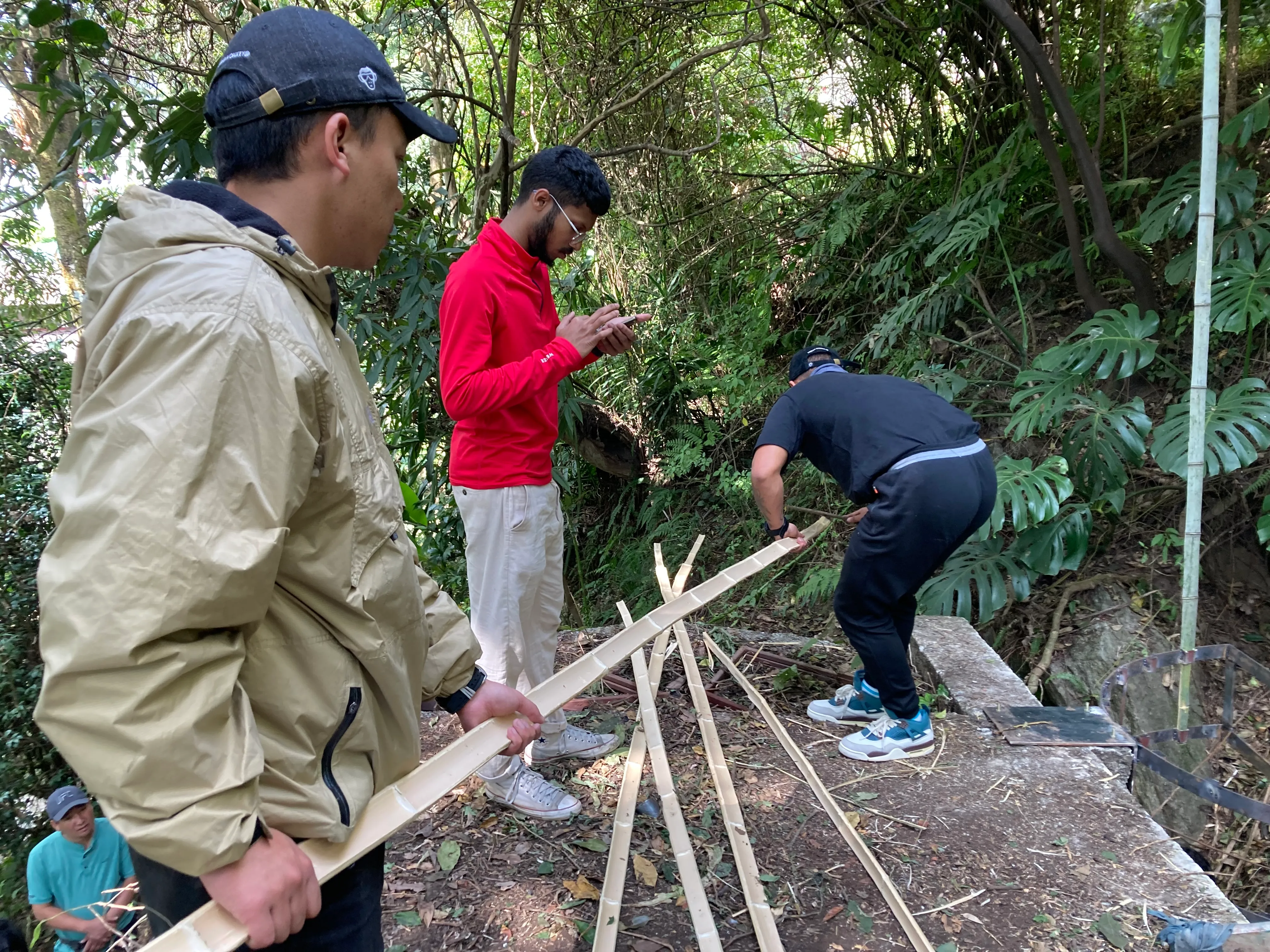 Long bamboo strips being prepared for pavilion construction